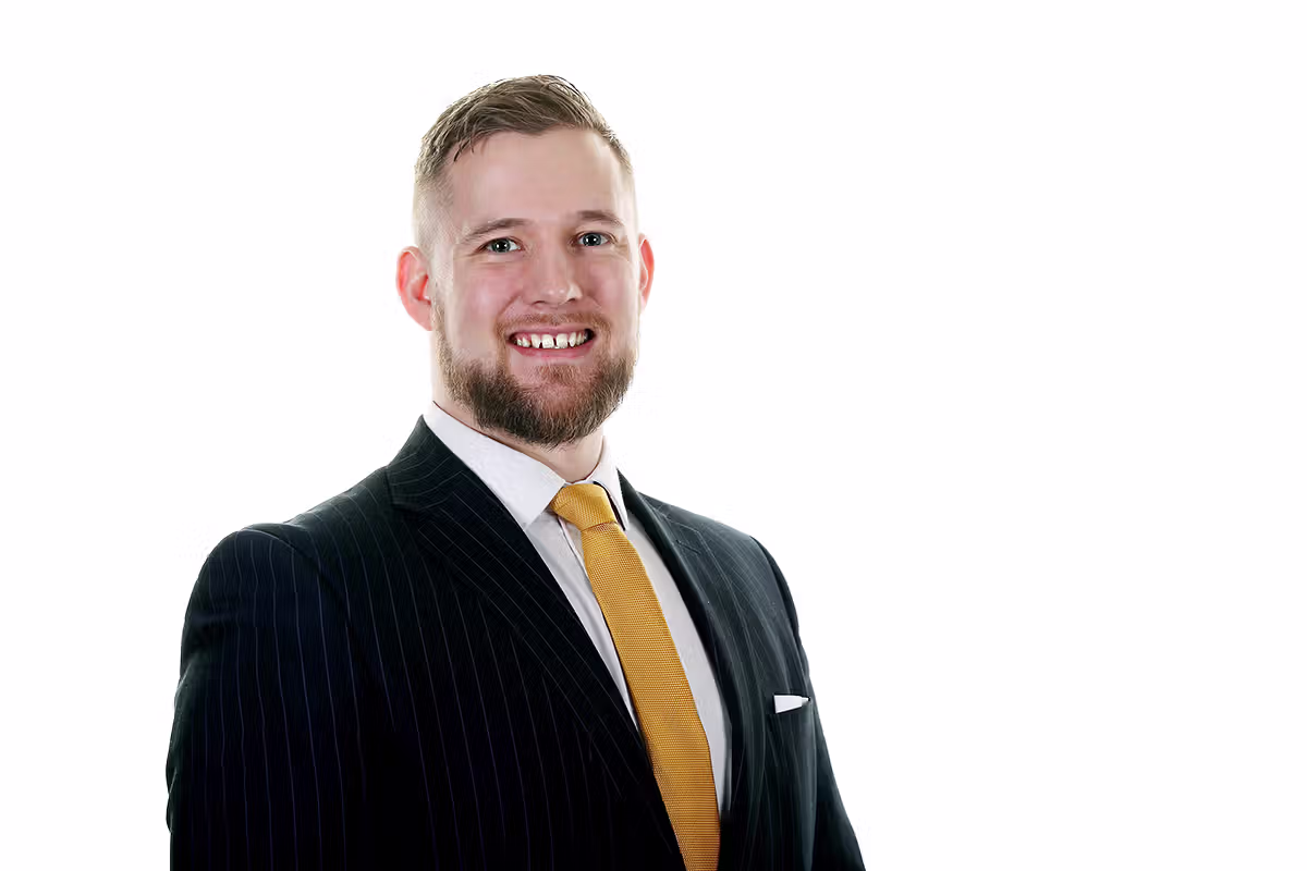 Business portrait of a professional in a suit with yellow tie on a white background