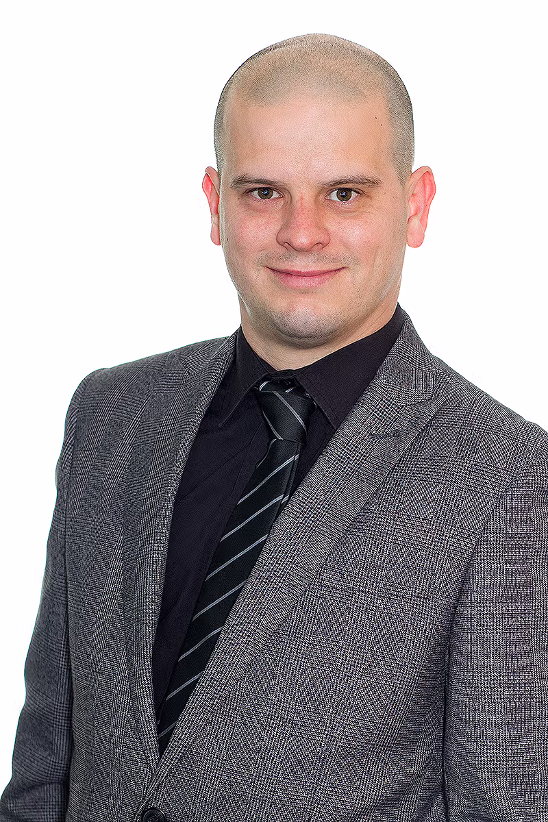 Business portrait of a professional in a grey jacket on a white background
