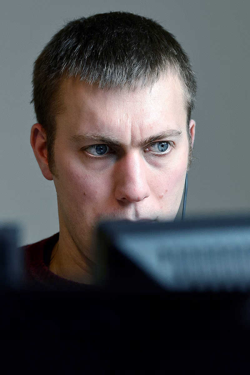 Office portrait of a business professional working at a computer