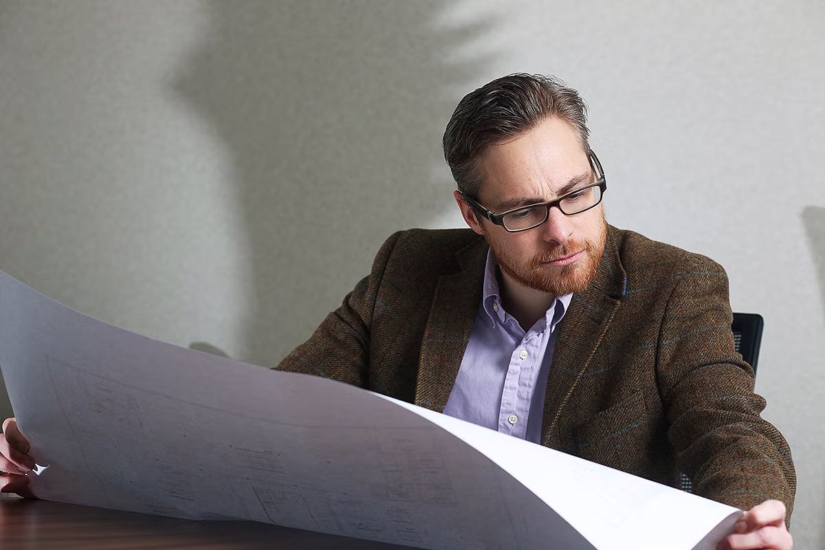 Internal communications portrait of business professionals reviewing documents