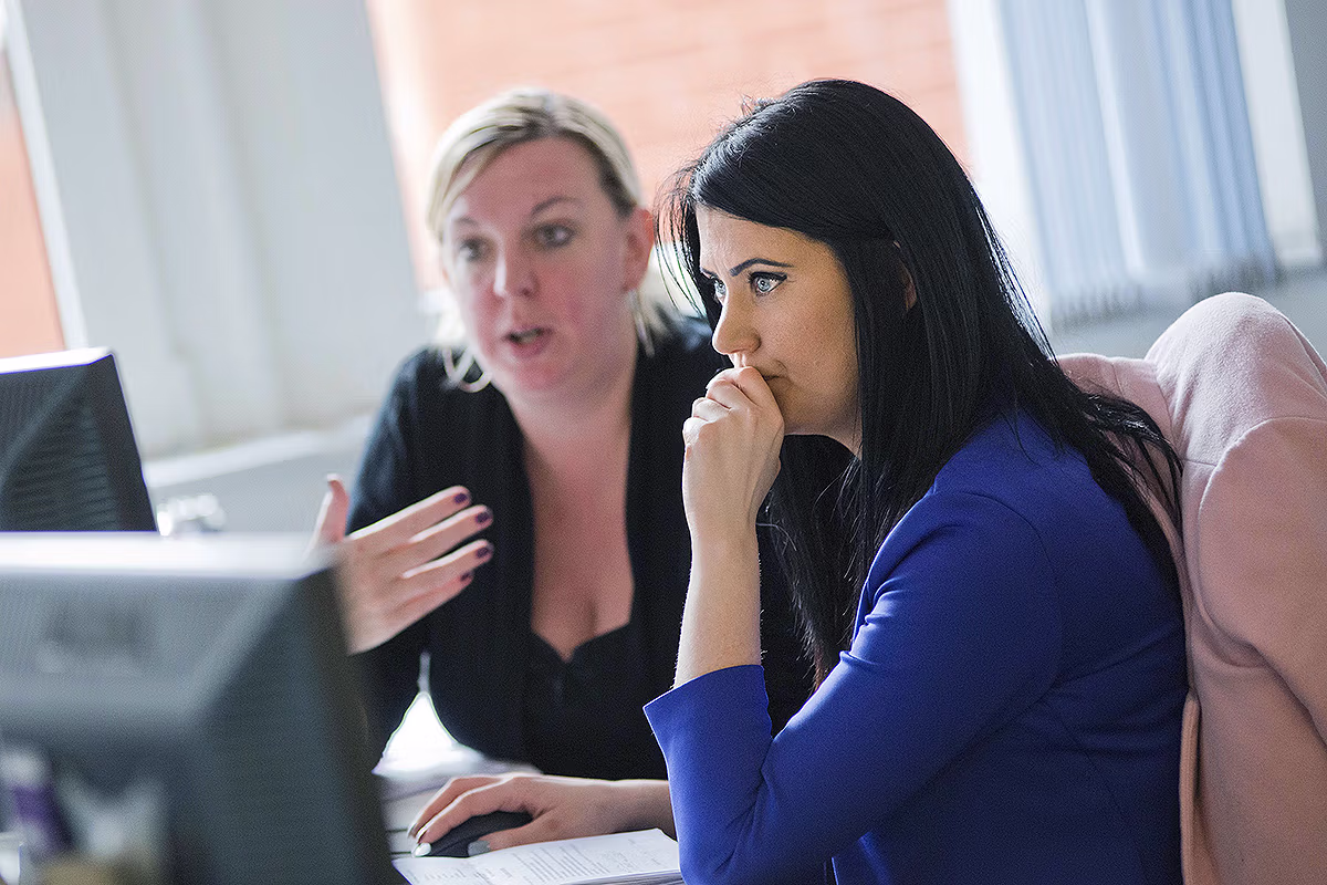 Employer brand photography of colleagues collaborating at an office desk