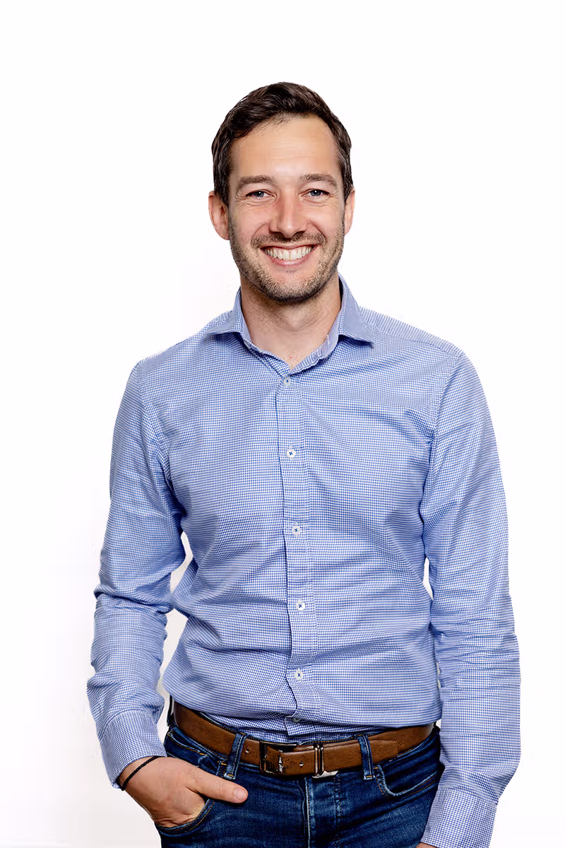 Professional male business headshot on a white background for corporate profile use