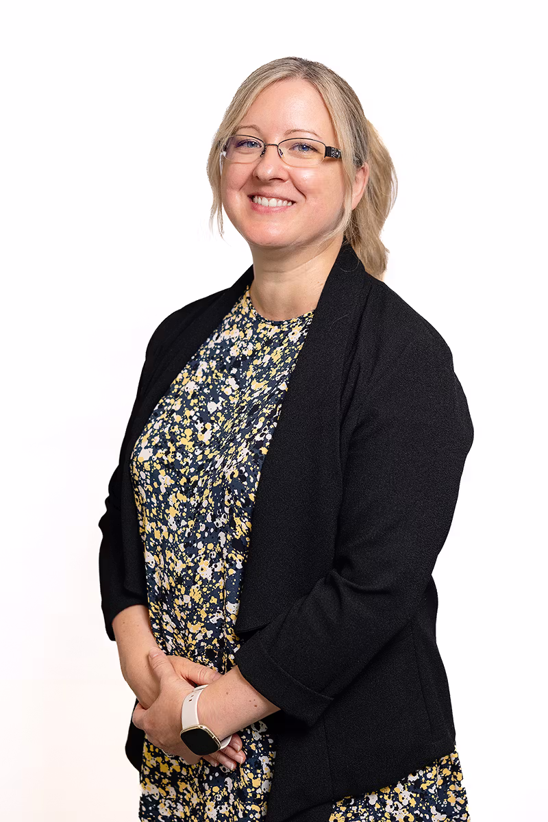 Professional business headshot of a woman with glasses on a white background