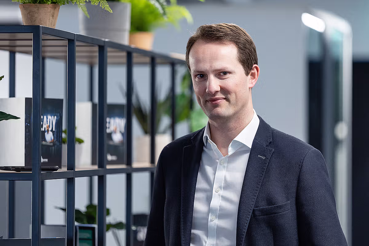 Environmental business headshot of a professional in an office workspace