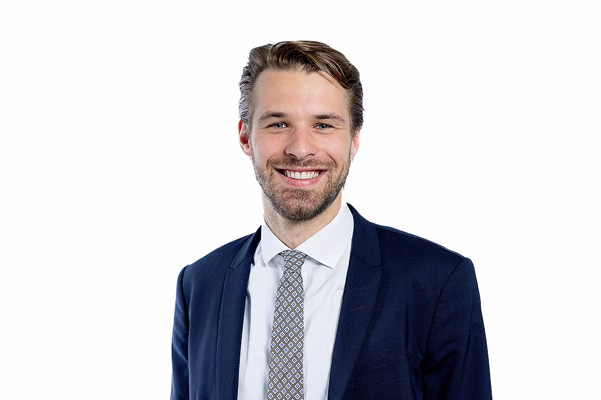 Executive headshot of a man in a suit on a white background for leadership profiles
