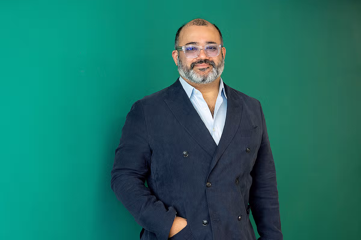 Executive portrait of a business leader against a green office background