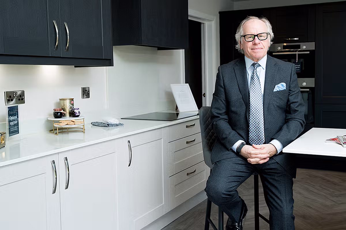 Senior leadership portrait of a business executive seated in a modern corporate interior