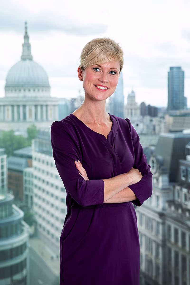 Corporate portrait of a businesswoman on a London rooftop with St Paul's Cathedral behind
