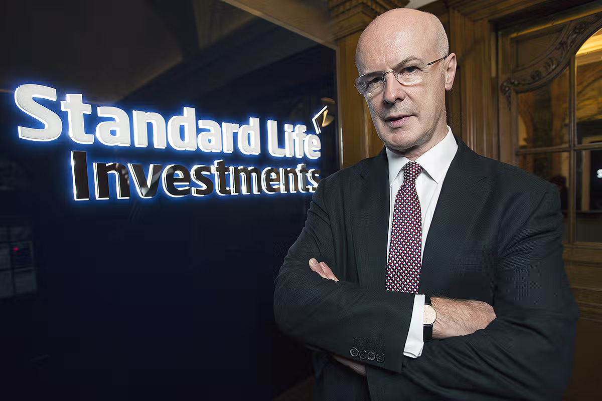Corporate portrait beside Standard Life branding at an event or office location