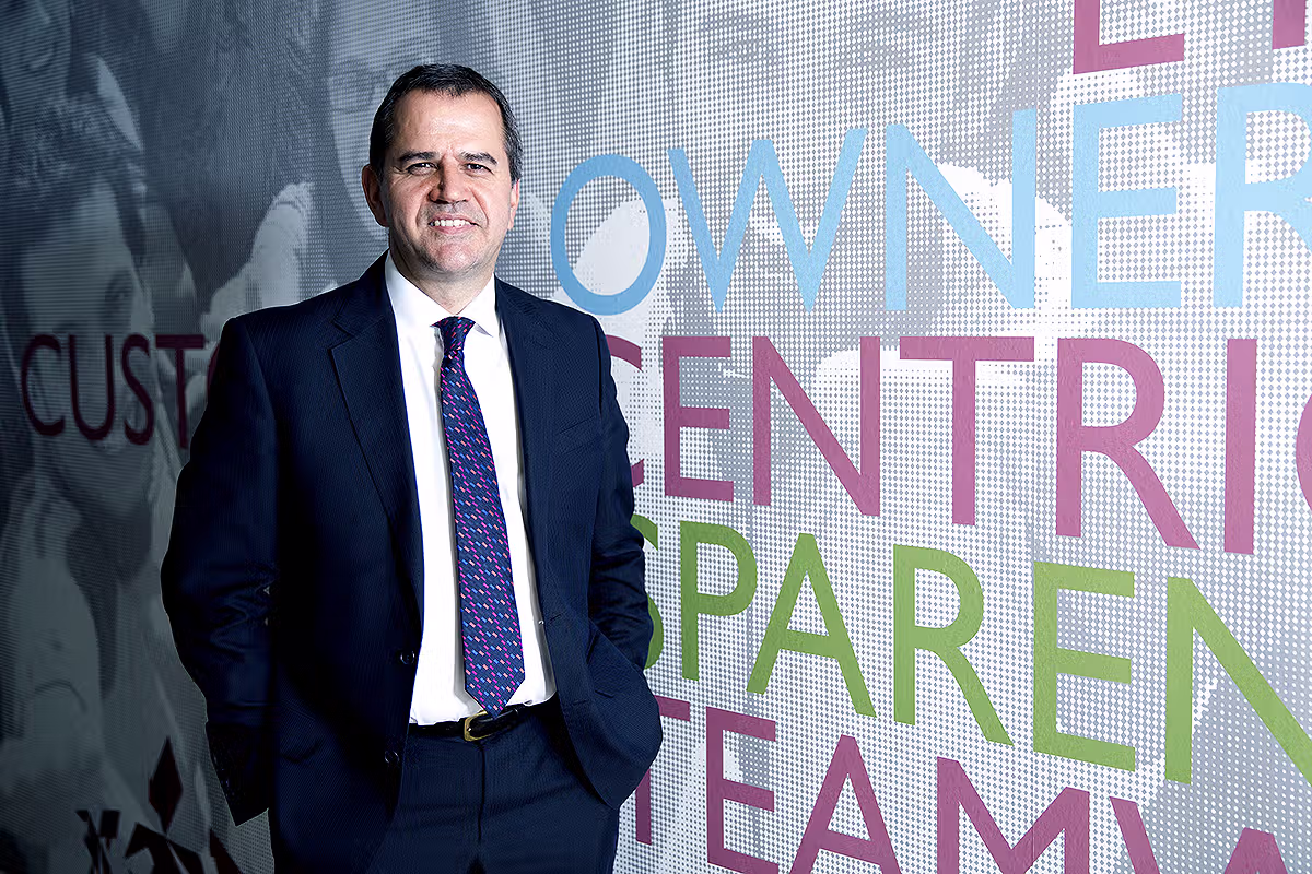 Corporate portrait of a businessman in front of office wall graphics