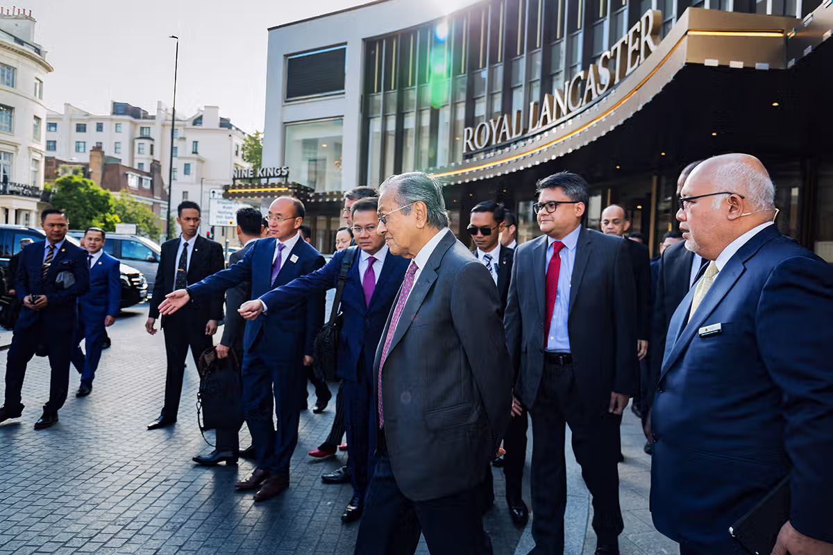 Business group walking through a London street during a formal visit or event