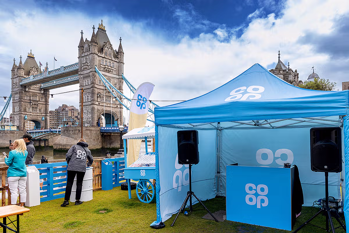 London PR photography showing Co-op branded festival activation with Tower Bridge and the Thames at Potters Fields Park
