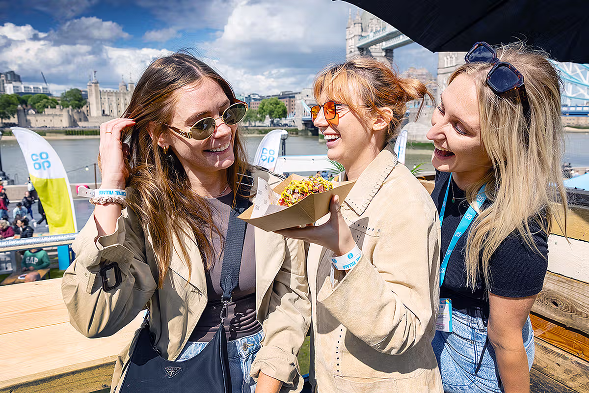 PR event photography in London showing guests enjoying Co-op Food Festival samples with Tower Bridge in the background