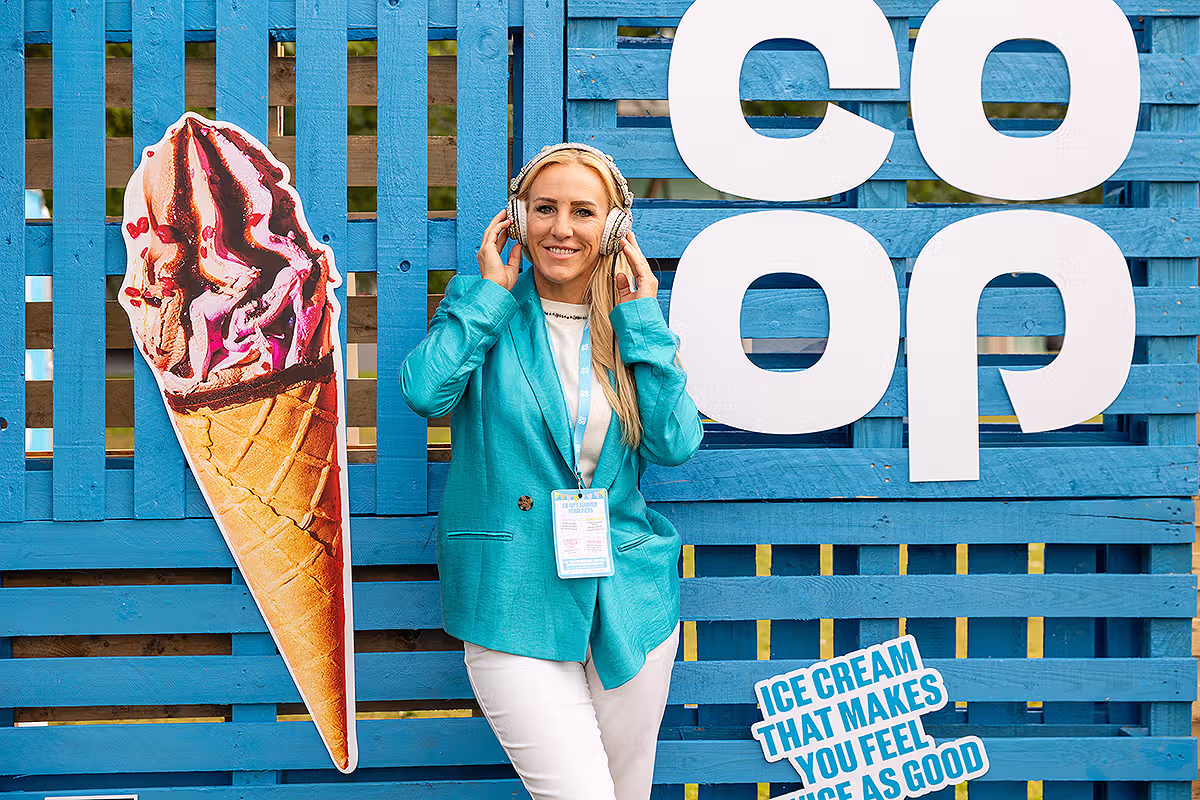 Co-op Food Festival brand activation photograph showing ice cream display, branded blue backdrop and festival host in London