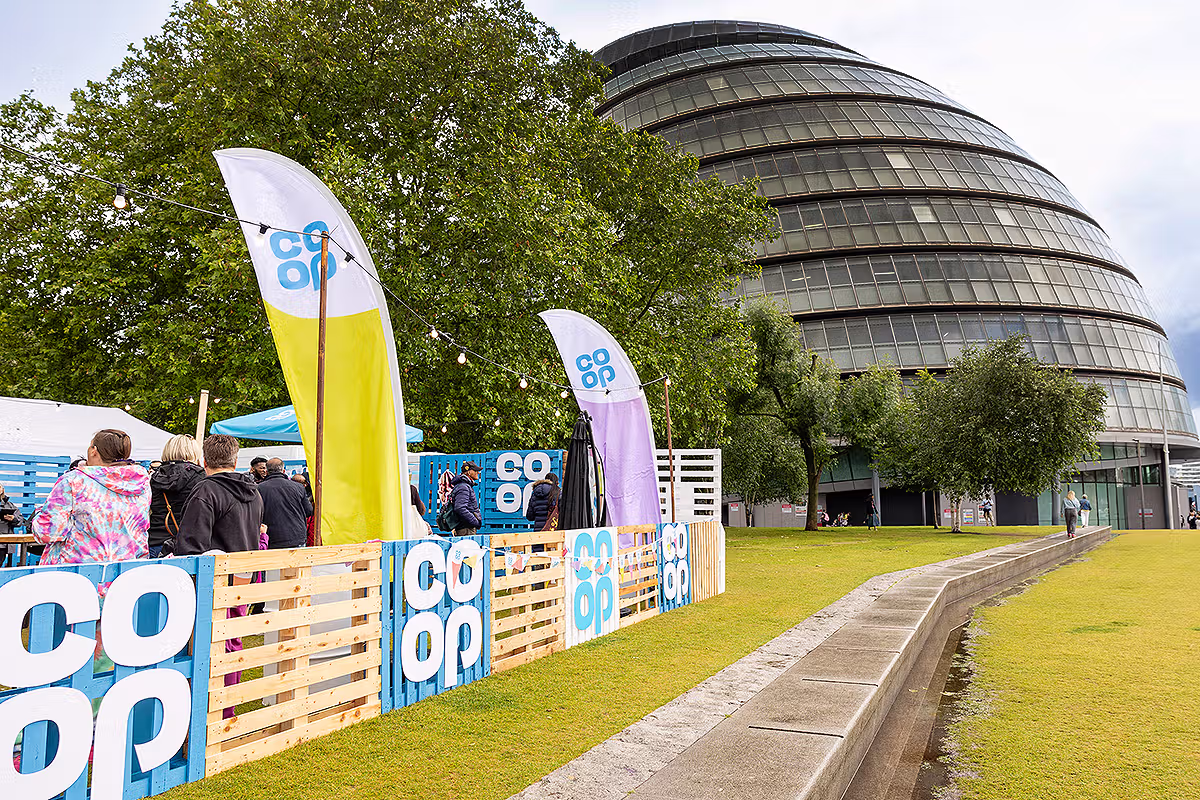 Co-op Food Festival PR photograph showing staff behind a branded bar area at Potters Fields Park in London
