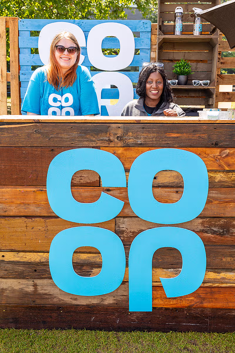 PR photography for Co-op Food Festival showing staff with branded merchandise and reusable bottle in the London Festival Village