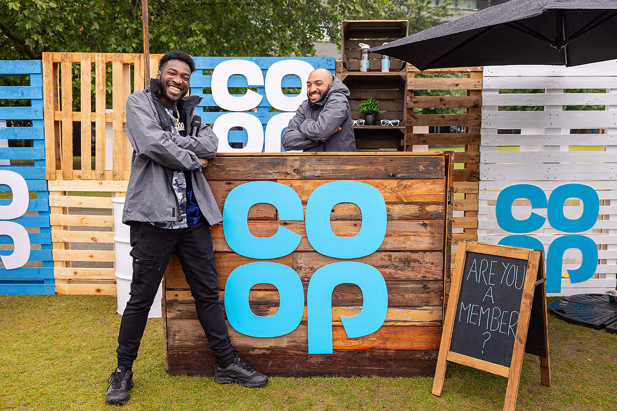 London PR photographer image showing Co-op Food Festival sample handout with Tower Bridge and branded tents in the background
