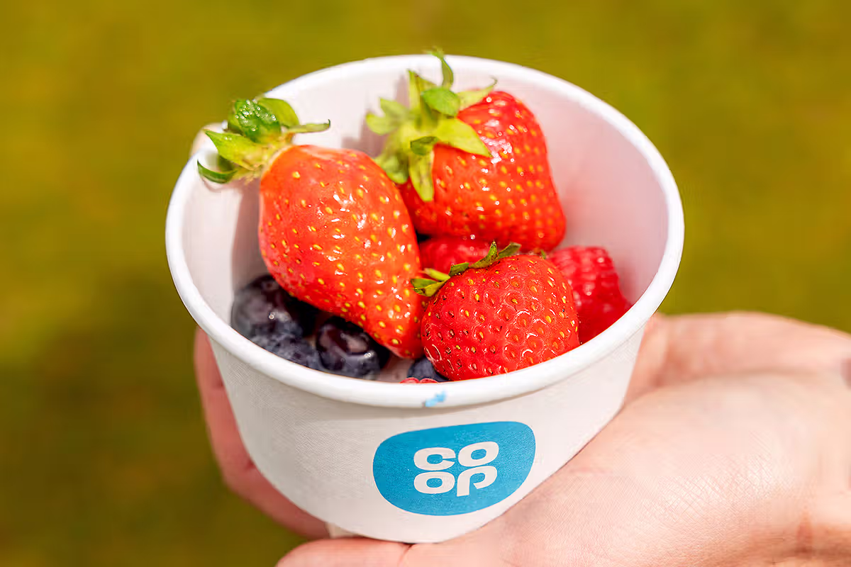 Close-up PR food image showing Co-op branded fruit cup with strawberries and blueberries during the London Food Festival activation