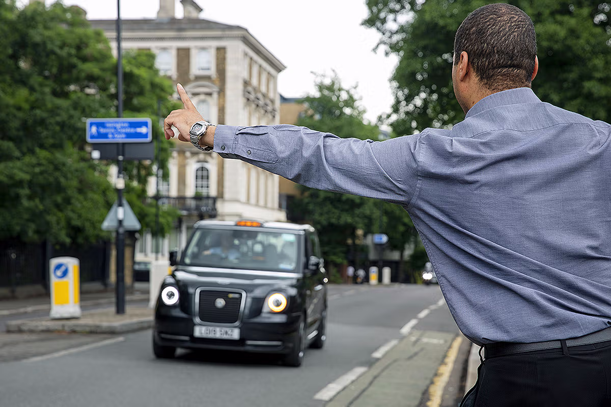 LEVC taxi driver hailing in a central London street scene photographed for PR and brand communications