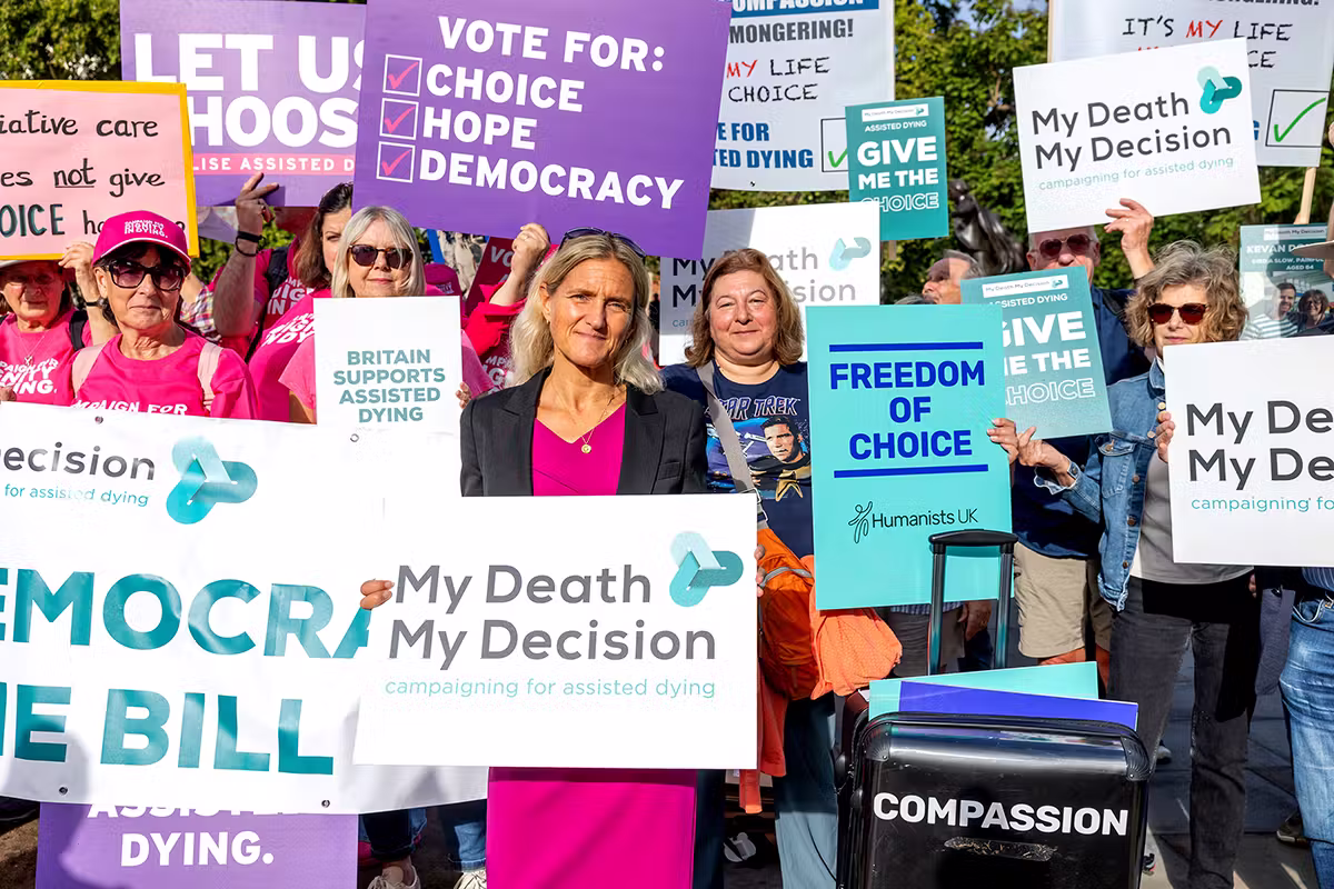 Public affairs campaign group in Westminster holding assisted dying, choice and democracy placards during a press-facing event